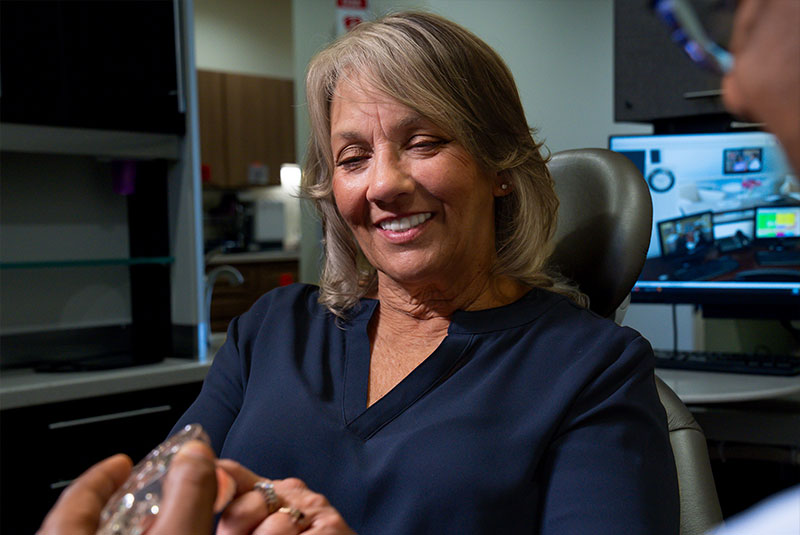 patient looking at dental model within the dental center